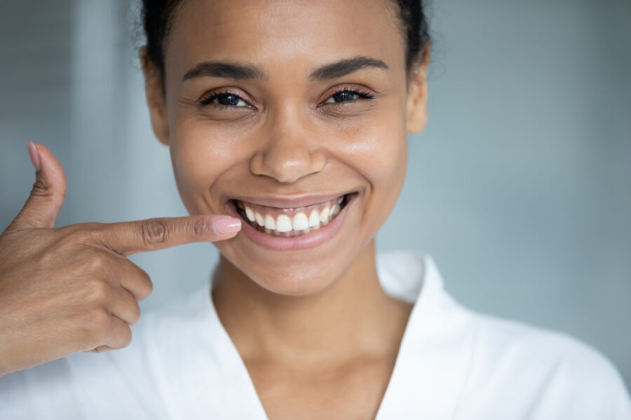 Happy,African,American,Girl,Pointing,Finger,At,Toothy,Smile,,Showing